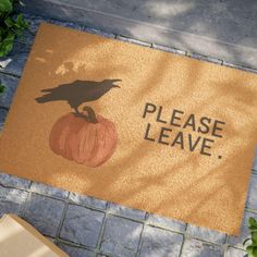 a door mat that says please leave with a black bird on top of a pumpkin