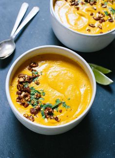 two bowls filled with soup on top of a table