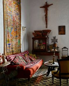 a living room filled with furniture next to a cross