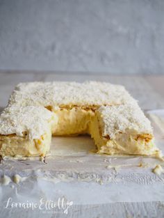 a cake that has been cut in half and is sitting on a piece of paper