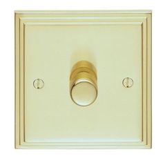 the light switch is gold and has two knobs on each side, which are both polished brass