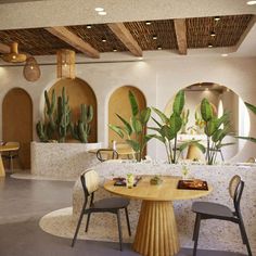 a dining area with tables and chairs, potted plants on either side of the table