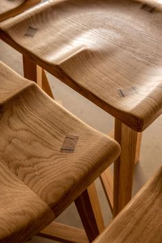 three wooden chairs sitting next to each other