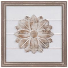 a wooden frame with a white flower on the front and bottom, painted in light brown