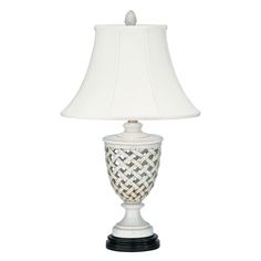 a white lamp with a black base and a white shade on the top of it