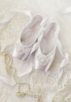 A beautiful pair of pure white pointe shoes, decorated with white embroidered lacy flowers and pearls. Very romantic and dreamlike, these pointe shoes could be a unique piece of wedding decor or a wonderful gift to a ballet dancer! They look beautiful hung by the ribbons or placed on display on your vanity desk or even a windowsill. The pair is new, never worn, the color of satin is originally white and never hand dyed, total length of a shoes 8 ½ inches. White tulle netting inserts included and Pointe Shoes Decorated, White Pointe Shoes, Decorated Pointe Shoes, White Ballet Slippers, White Ballet Shoes, Point Shoe, Ballerina Room, Flowers And Pearls, Spanish Dance