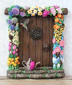 a wooden door decorated with flowers and a watering can