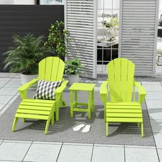 an outdoor patio with green chairs and a table on the ground next to a potted plant