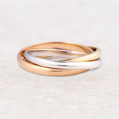 two gold and silver wedding bands on a white background