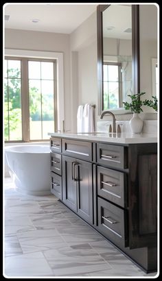 a bathroom with a tub, sink and large mirror