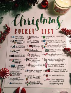 a christmas bucket list with candy canes and ornaments around it on a white table