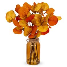 a vase filled with orange and yellow leaves