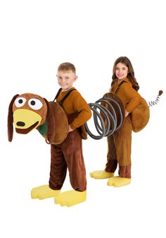 two children dressed up in costumes and one is holding a monkey costume while the other holds a