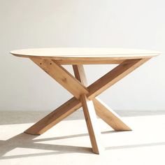 a wooden table sitting on top of a white floor