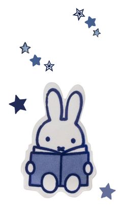 a blue and white sticker with a rabbit reading a book in front of stars