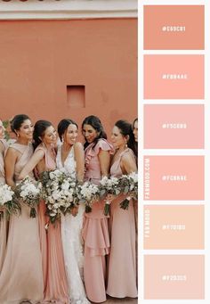 a group of women standing next to each other in front of a pink wall with white flowers