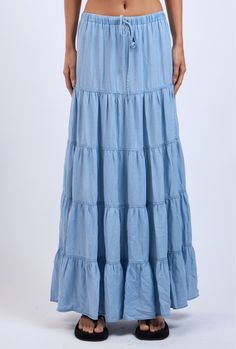 The Denim Days Maxi Skirt features a lightweight denim fabric and tiered ruffle design. Perfect for year-round wear and has an drawstring waistband for all-day comfort Material & Care: Made from 100% Tencel. For best care, machine wash cold with like colors on a gentle cycle. Use a mild detergent. Avoid bleach. Hang to dry. Iron on low heat if needed Size & Fit: Model is 5'8" wearing size small Bust: 34B Waist: 24 Hips: 34 Tiered Denim Skirt For Spring, Denim Blue Tiered Cotton Skirt, Denim Blue Tiered Skirt For Summer, Summer Medium Wash Tiered Skirt, Cotton Denim Blue Tiered Skirt, Medium Wash Cotton Tiered Skirt, Flowy Denim Tiered Skirt, Spring Denim Tiered Ruffled Skirt, Blue Tiered Ruffled Denim Skirt