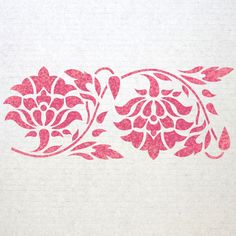 a pink stencil on white paper with flowers and leaves in the center,