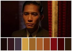 a man in a suit and tie is looking at the camera with color swatches