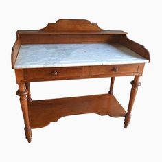 an old wooden desk with marble top and drawer on one side, against a white background