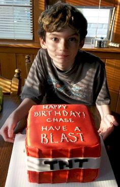 a boy sitting at a table with a birthday cake in front of him that says happy birthday chase have a blast