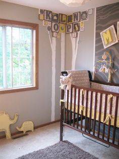 a baby's room decorated in gray and yellow