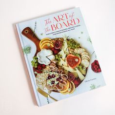 the art of the board cookbook on a white surface