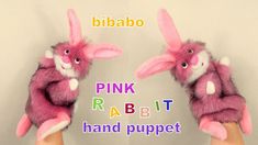 two pink rabbits are held in their hands with the words pink rabbit hand puppet above them