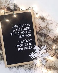 a black board with white writing on it and snowflakes in the background that says christmas is a together, sort of holiday said pooh