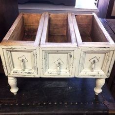 an old dresser with two drawers and knobs on the bottom, sitting on a table