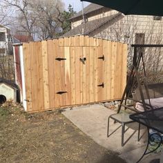 a large wooden fence next to a yard