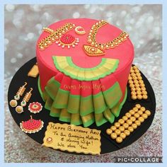 a birthday cake decorated with jewelry on a table