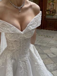 a woman in a wedding dress is posing for the camera