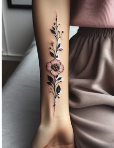 a woman with a flower tattoo on her left arm and the other side of her leg