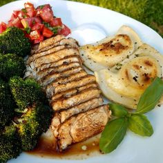 a white plate topped with meat and veggies