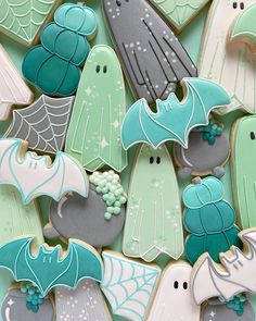 decorated cookies with bats, bats and spider webs in pastel green and gray