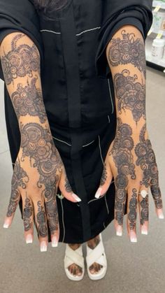 a person with tattoos on their arms and hands