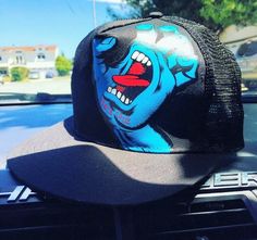 a blue and black hat on top of a car