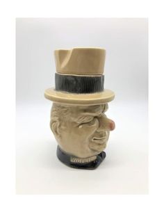 a ceramic head with a top hat on it