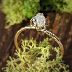 a diamond ring sitting on top of a wooden table