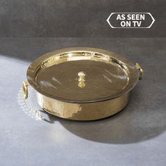 a gold tray with a handle and handles on the side, as seen on tv