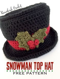 a crocheted black hat with red and green flowers on the brim is shown