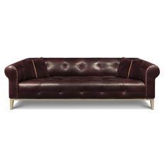 a brown leather couch with gold trimmings on the arms and back, against a white background