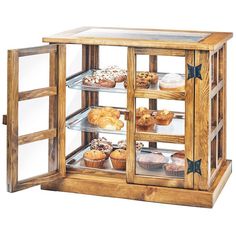 a wooden display case filled with lots of pastries and muffins in it