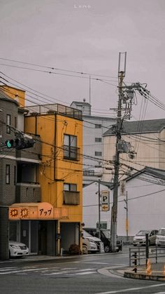 an intersection with cars and buildings in the background