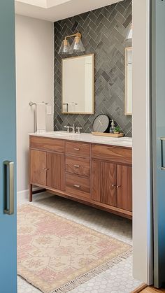 This luxury primary bath is anchored by a slate tile backsplash in a herringbone pattern that immediately brings the eye into the space. The mixed metal finishes, wood vanity, and hexagon tile floor add interest and depth to the space. This bathroom hits just the right balance of masculine and feminine. Walnut Creek California, Bath Renovation, Herringbone Tile, Walnut Creek, Ensuite Bathroom, Living Room Accent Tables, Modern Baths, Bathroom Backsplash, Wood Vanity