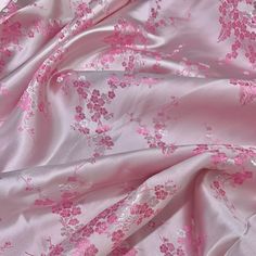 the pink fabric has flowers on it and is very soft enough to put in this photo