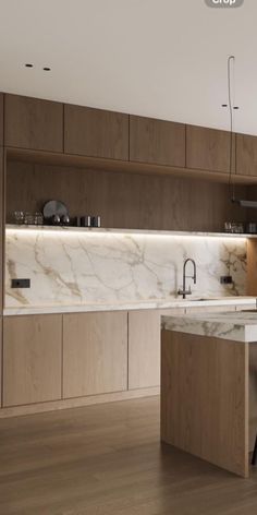 a kitchen with wooden cabinets and white marble counter tops, along with an island in the middle