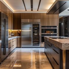 a modern kitchen with stainless steel appliances and marble counter tops