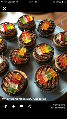 there are many cupcakes with candies on the top and chocolate icing